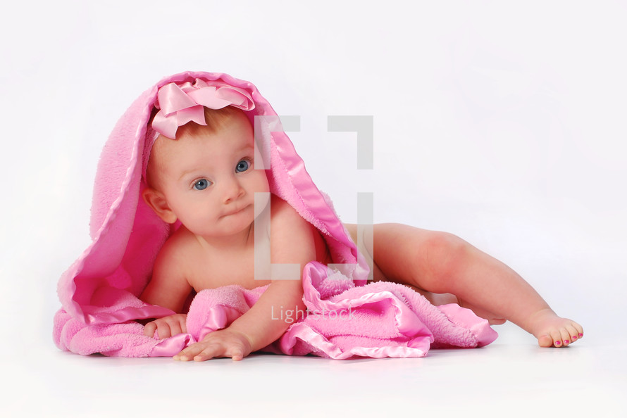 infant girl under a pink blanket