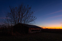 Rural wood structure at sunset
