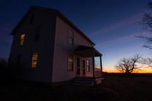 White farm house at dusk