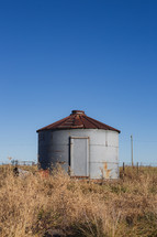 Rusty silo in a field