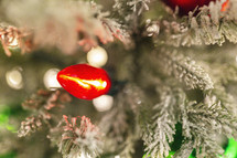 bokeh lights and red and green Christmas lights on a Christmas tree