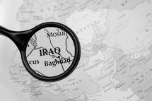 magnifying glass over a map of Iraq