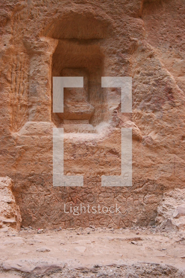 Niche and writing on a wall in Petra