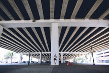 woman standing under an overpass 