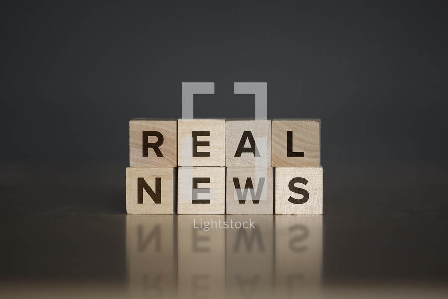 real news words on wooden blocks 