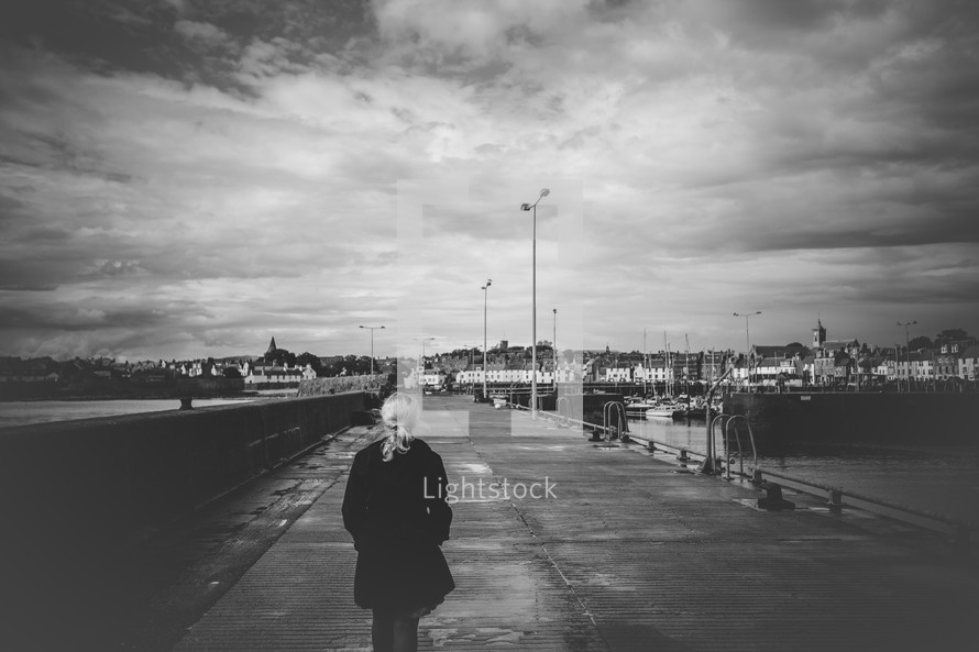 woman walking near a harbor 