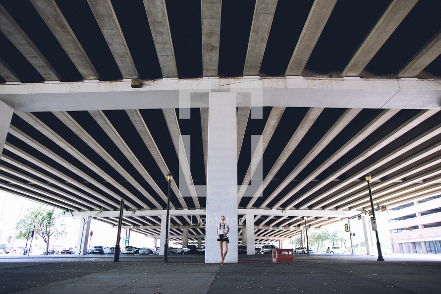 woman standing under an overpass 