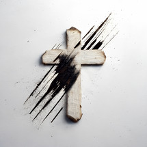 Wood Cross with black ashes on a white background