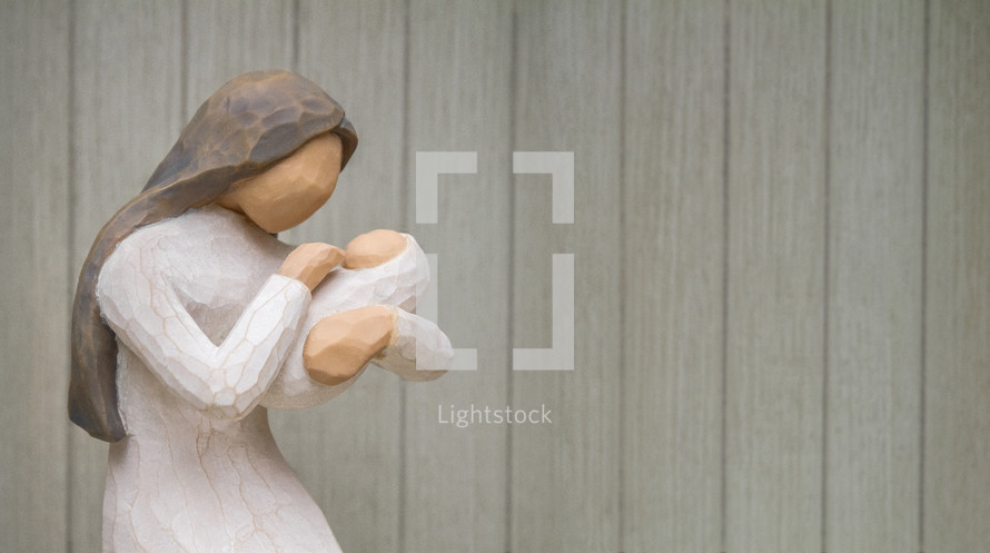 Figurine of Mary holding baby Jesus.