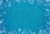 bokeh dots on teal glitter background 
