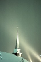 a church steeple in snow 