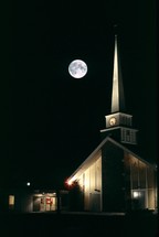 full moon over a church 