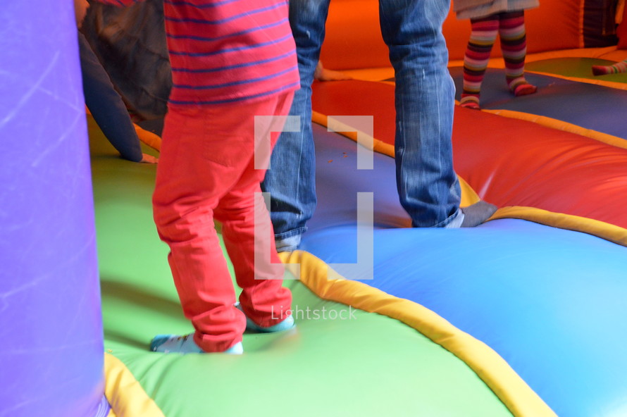 children bouncing in a bounce house. 