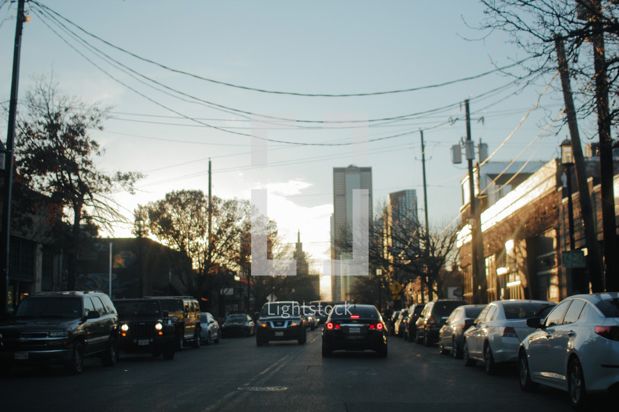 traffic on a downtown street at sunset 