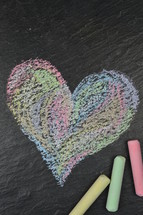 heart shape in sidewalk chalk on slate with copy space above
