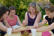 women's group reading scripture and praying together 