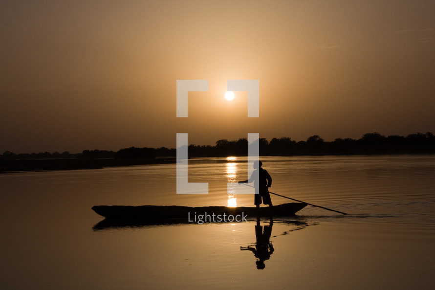 Silhouette of boat at sunset