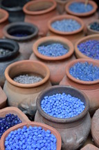beads in pottery jars at a market 