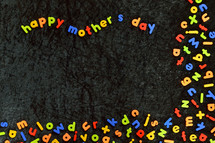 many magnetic letters and the words HAPPY MOTHER'S DAY on black velvet ground.