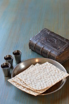 The Lord's Supper with bread, wine and an ancient bible. 