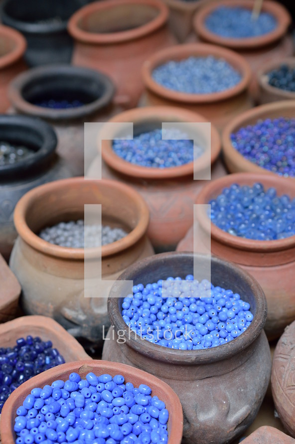 beads in pottery jars at a market 