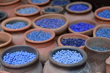 blue beads in pottery jars 