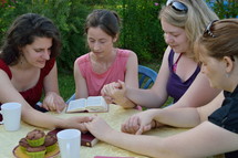 women's group reading scripture and praying together 