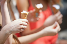 three girls holding ice cream cones 