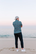 a man standing on a beach 