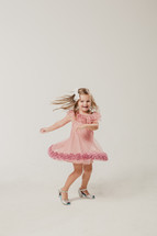 little girl dancing in a dress 