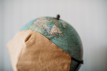 face mask over a globe 