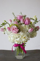 a vase of white and pink flowers 