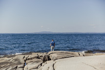a man standing on a shore 