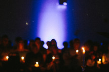 people holding candles at a candlelight service 