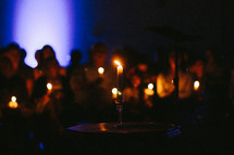 people holding candles at a vigil 