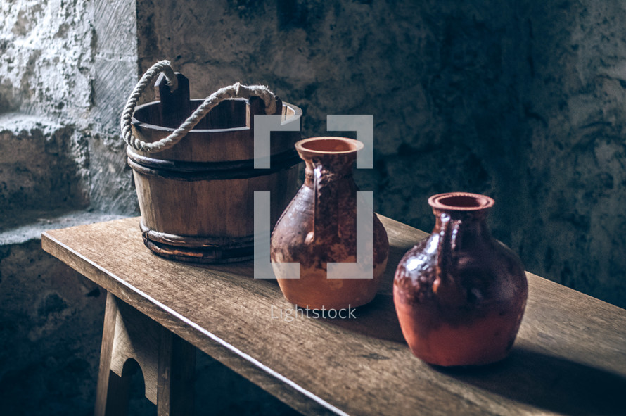 wooden bucket and pottery jugs