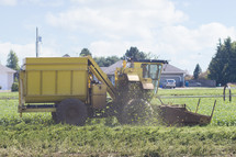 a combine tractor plowing a field 