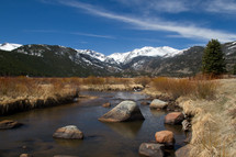 stream and snow capped mountain peaks