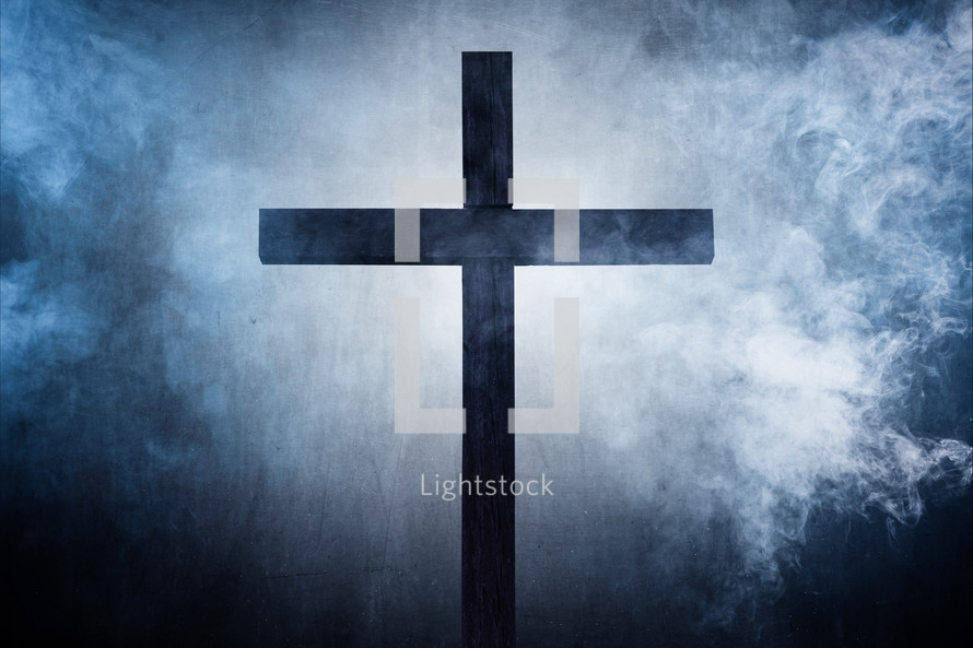 wood cross on smoky gray background 