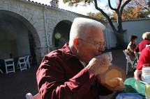 an elderly man drinking tea 
