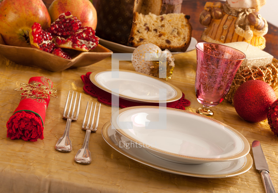 Table decorated for Christmas dinner with warm lighting