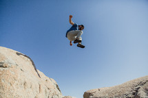 a man leaping over rocks 