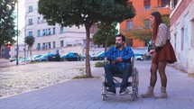 a conversation between a man in a wheelchair and a woman 