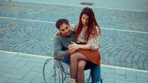a couple hugging - man in a wheelchair - love 