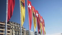 Flags Of Geneva And Switzerland In The Wind 
