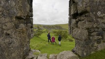 Family Exploring Dartmoor Village Ruins Mother Daughter And Son