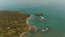 Cinematic flight over coastline of Punta Mona with tropical forest and beach in Costa Rica - Beautiful wide view of Caribbean Sea