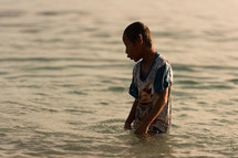 boy standing in the water 