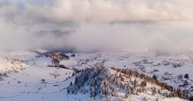 Aerial Drone Shot of mountains in snow during winter in Cheile Gradistei Fundata, Romania.