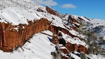 Early frozen mid winter fresh snow snowed in on red rocks boulders
